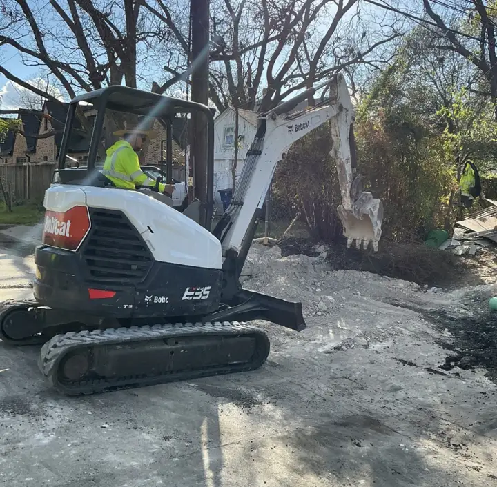 Bobcat E35 mini excavator digging on a residential jobsite