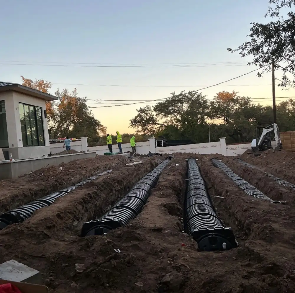 Septic field chamber system being installed in parallel trenches at a residential site